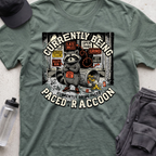 CURRENTLY BEING PACED BY A RACCOON  T-shirt