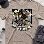 CURRENTLY BEING PACED BY A RACCOON  T-shirt